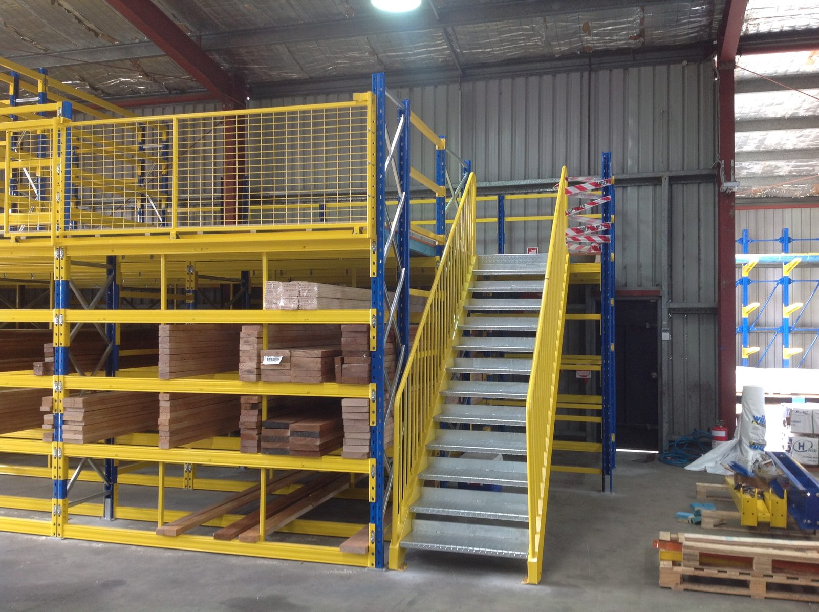 Two level pigeon hole racking with mezzanine floor